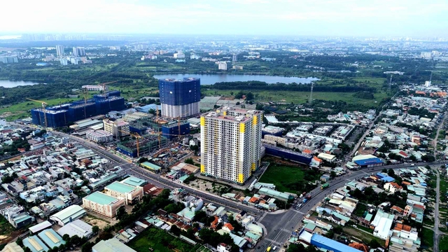 Tháp căn hộ Bcons City – trung tâm tiện ích của làng Đại học đang thi công lên tầng (Ảnh: Huyền Trang)